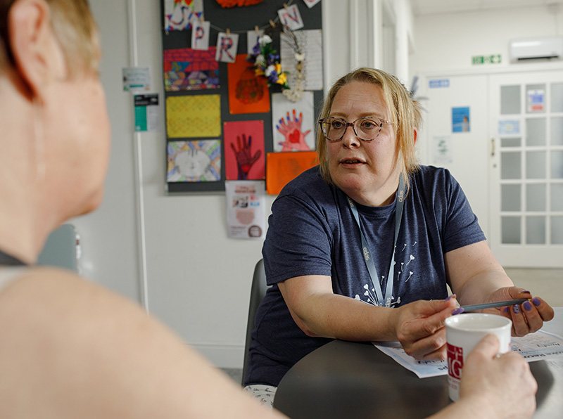 CDAS Recovery Worker sitting with a client and speaking with them over a cup of tea