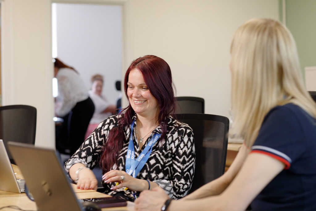 CDAS staff chatting at a desk