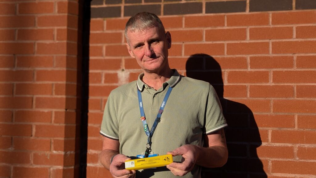 Staff member Steve holding naloxone